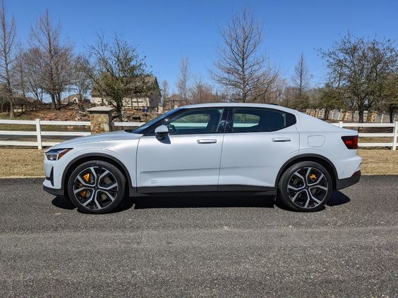 The 2024 Polestar 2 parked against a scenic backdrop, showcasing its sleek design and modern features.