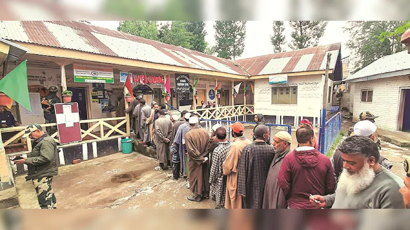 The third phase of Jammu and Kashmir polls witnessed over 20,000 polling staff deployed, ensuring a smooth voting process that began at 7 a.m. with enhanced security measures. Alt Text: Voters