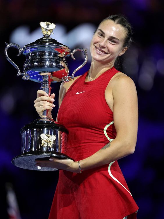 Aryna Sabalenka celebrating a victory on the tennis court.